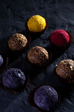 Colored round candies on a dark background.の写真素材