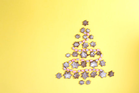Concept Christmas tree lined with snowflakes gingerbread cookies sprinkled with icing sugar and...