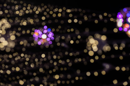 Christmas lights with small highlights sparkles on a dark background. Out of focus, blues. Festive...