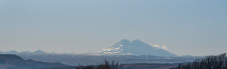 Panoramic view of the Caucasus Range and Mount Elbrus. The mountains are stark on the horizon in a...