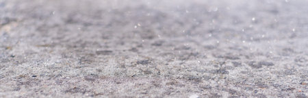 Concrete gray texture macro with blur bokeh. Shiny web banner for background with copy space.