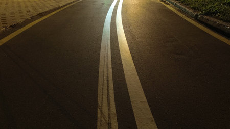 Asphalt bike path with markings at night