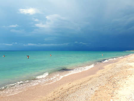View of the turquoise sea and cliffs from the beachの写真素材