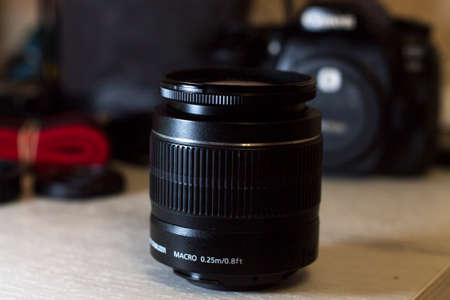 Lens on the table and a camera in the backgroundの写真素材