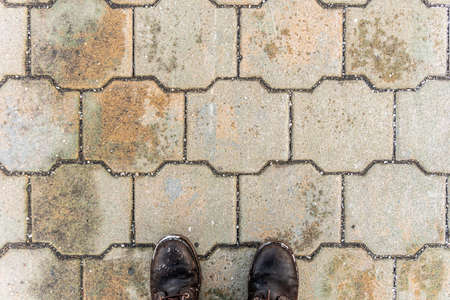 Fray stone paving slabs and feet, stone background, paving stone patternの写真素材
