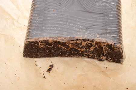 broken into several parts pieces of chocolate from cocoa, natural food from cocoa, pieces of large...