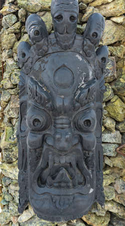 Decorative gruesome mask, house with devils in the village of Ratomka, a unique ominous structure, a house with skulls, a house with forged decorationsの写真素材