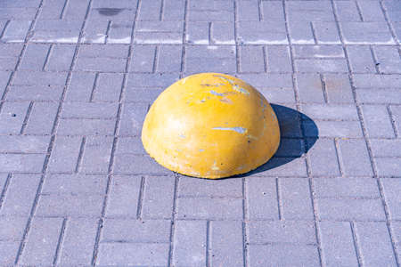 Concrete protective pavement hemisphere, scratched yellow pavement hemisphereの写真素材