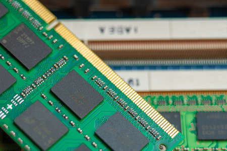 Master holds Laptop RAM close up on motherboard backgroundの写真素材