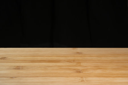 Wooden board empty table in front of black background. Perspective brown wood can be use for display...