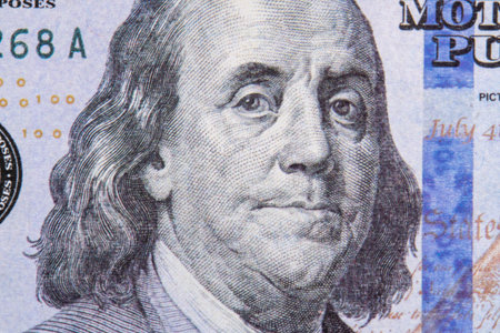 Benjamin Franklin portrait macro usa dollar banknote or bill. Benjamin Franklins look on a one hundred dollar billの写真素材