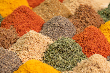 Heap different Asian Spices lies on wooden background. Spice and seasoning. Various fragrant spice market. Assortment spices and herbs for cookingの写真素材