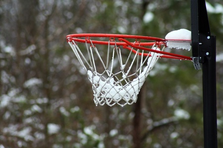Close up of snow covered basketball netの写真素材