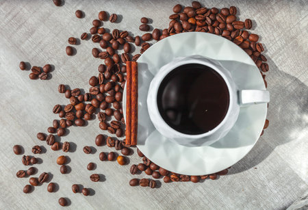 cup of coffee on the plate with cinnamonの写真素材