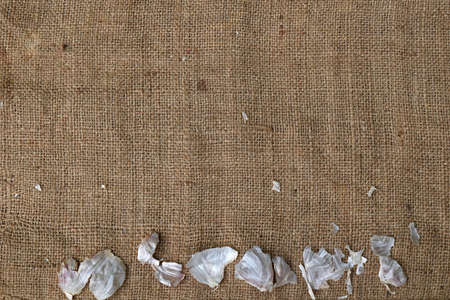 White garlic peel on isolated jute backgroundの写真素材