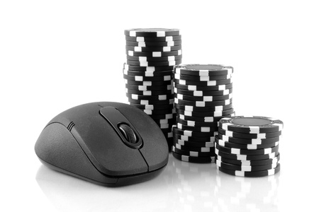 Online gaming and gambling concept, a mouse and black casino chips on white backgroundの写真素材