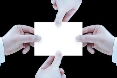 Hands holding white card on black backgroundの写真素材