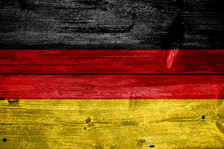 Germany flag painted on old wood plank backgroundの写真素材