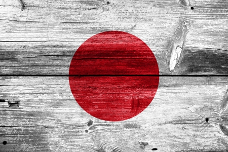 Japan flag painted on old wood plank backgroundの写真素材