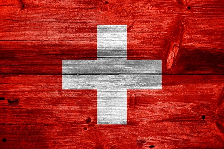 Switzerland flag painted on old wood plank backgroundの写真素材