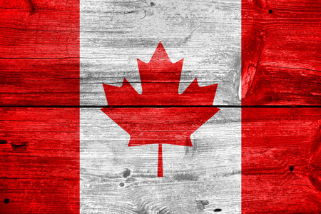 Canada flag painted on old wood plank backgroundの写真素材