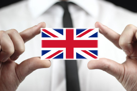 Businessman holding a business card with a UK Flagの写真素材