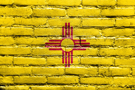 New Mexico State Flag painted on brick wallの写真素材