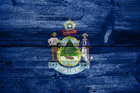 Maine State Flag painted on old wood plank textureの写真素材