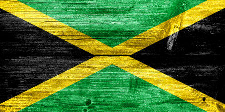 Jamaica Flag painted on old wood plank textureの写真素材