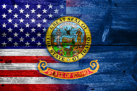 USA and Idaho State Flag painted on old wood plank textureの写真素材