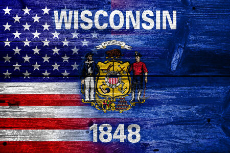 USA and Wisconsin State Flag painted on old wood plank textureの写真素材