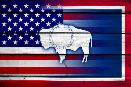 USA and Wyoming State Flag on wood backgroundの写真素材