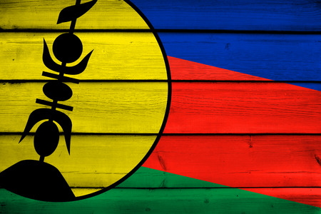 New Caledonia Flag on wood backgroundの写真素材