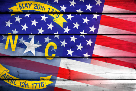 USA and North Carolina State Flag on wood backgroundの写真素材