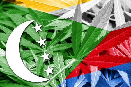 Comoros Flag on cannabis background. Drug policy. Legalization of marijuanaの写真素材