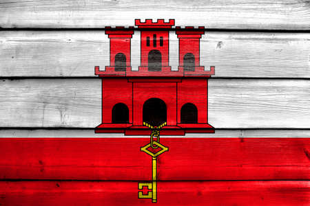 Flag of Gibraltar, painted on old wood plank backgroundの写真素材