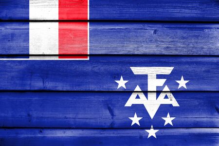 Flag of the French Southern and Antarctic Lands, painted on old wood plank backgroundの写真素材