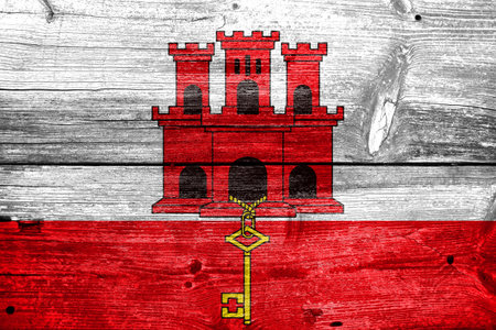 Flag of Gibraltar, painted on old wood plank backgroundの写真素材
