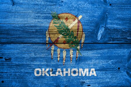 Flag of Oklahoma State, painted on old wood plank backgroundの写真素材