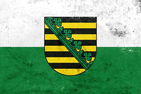Flag of Saxony with Coat of Arms, Germany, with a vintage and old lookの写真素材
