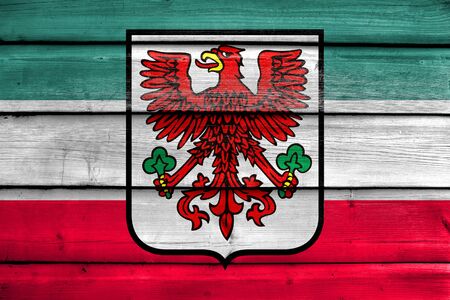 Flag of Gorzow Wielkopolski with Coat of Arms, Poland, painted on old wood plank backgroundの写真素材