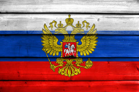 Flag of Russia with Coat of Arms, painted on old wood plank backgroundの写真素材