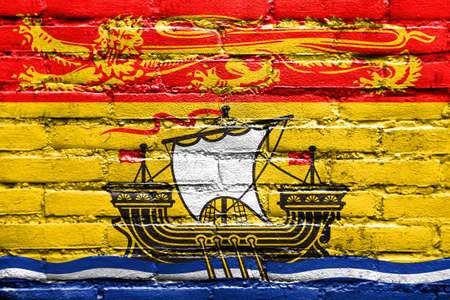 Flag of New Brunswick Province, Canada, painted on brick wallの写真素材