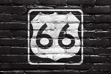 U.S. Route 66 (US 66 or Route 66), also known as the Will Rogers Highway and also known as the Main Street of America or the Mother Road, painted on brick wallの写真素材