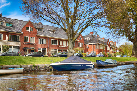 HAARLEM, NETHERLANDS - APR 30, 2017 : Canal with historical houses in old Haarlem. Typical Dutch architecture. View from the boat level.のeditorial素材