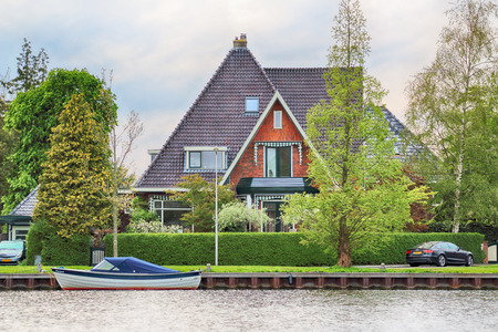 HAARLEM, NETHERLANDS - APR 30, 2017 : Canal with modern Dutch architecture. View from the boat level.のeditorial素材