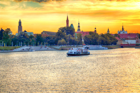 WROCLAW, POLAND - AUGUST 8, 2017: Wroclaw Old Town. Cathedral Island (Ostrow Tumski) is the oldest part of the city. Odra River, boats and historic buildings during the beautiful sunset.のeditorial素材