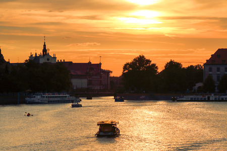 WROCLAW, POLAND - AUGUST 8, 2017: Wroclaw Old Town. Cathedral Island (Ostrow Tumski) is the oldest part of the city. Odra River, boats and historic buildings during the beautiful sunset.のeditorial素材