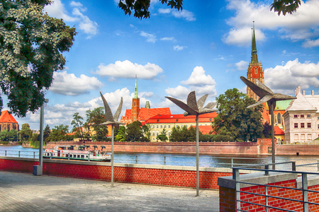 WROCLAW, POLAND - AUGUST 14, 2017: Wroclaw Old Town. Cathedral Island (Ostrow Tumski) is the oldest part of the city. Odra River, boats and historic buildings on a summer day.のeditorial素材
