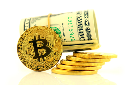Physical version of Bitcoin (new virtual money) and banknotes of one dollar. Exchange bitcoin for a dollar. Conceptual image for worldwide cryptocurrency and digital payment system.の写真素材